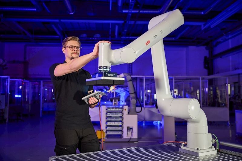 A technician trains a PoWa robot