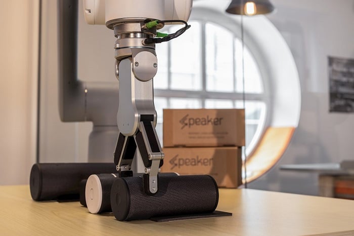 GoFa robot lifting a small speaker