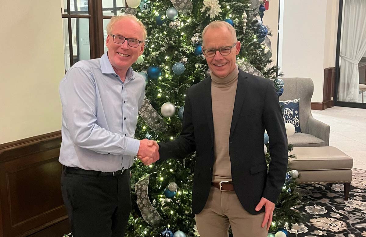 Red Lion Controls CEO and HMS Networks CEO shake hands after signing acquisition deal