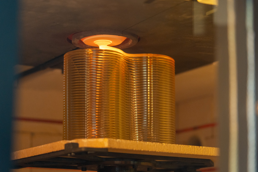 Molten glass being 3D printed into a figure eight design