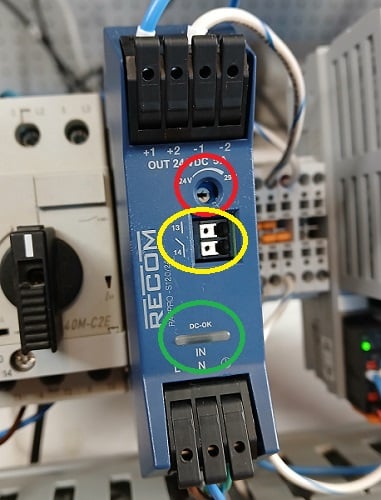 Figure 4. This power supply has an output status contact (yellow), status LED (green), and voltage adjustment (red).