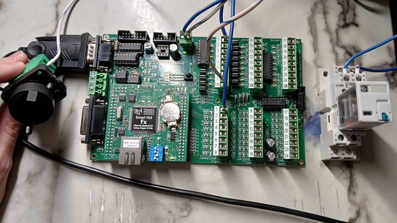 Figure 2. The complete project hardware: power, a serial cable, an input switch (left), and a relay (right).