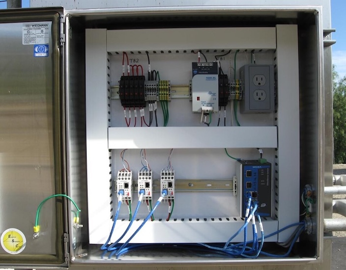 Installation of Modbus converters in a communication panel.