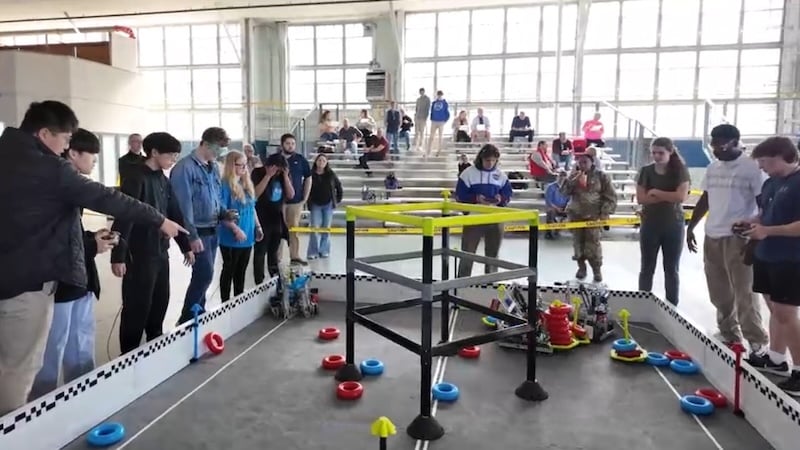 Students taking part in Maxwell’s robotics competition engage in physical robotics-led stacking tasks