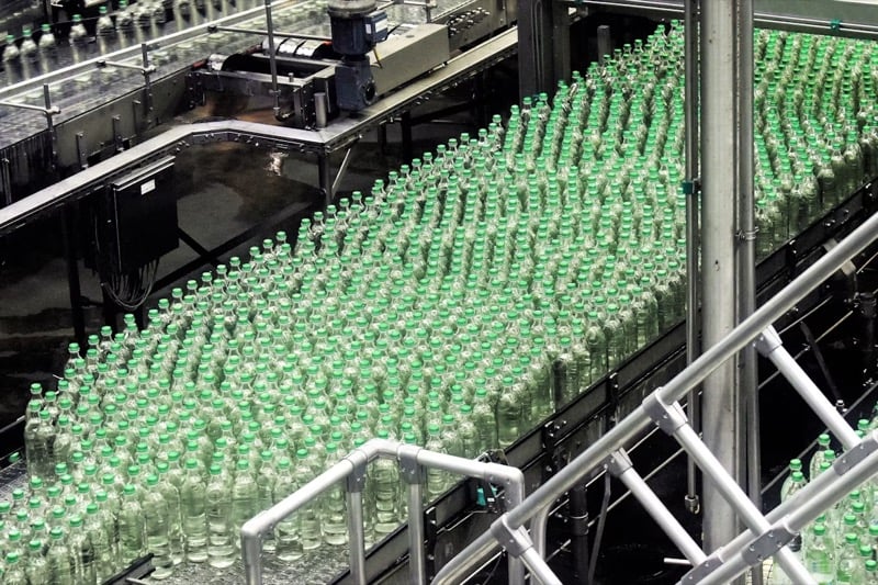 A bottling line that uses conveyors driven by AC motors to move bottles around the plant.