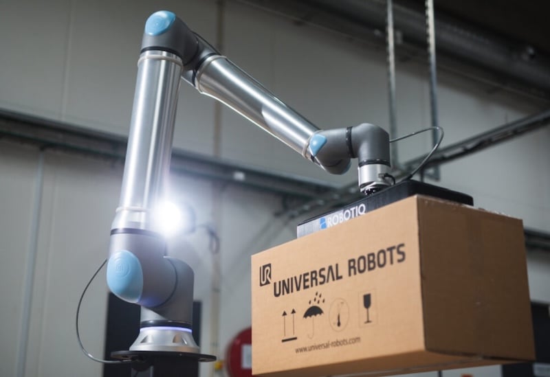 Universal Robots (Teradyne Robotics) industrial cobot handling packages.