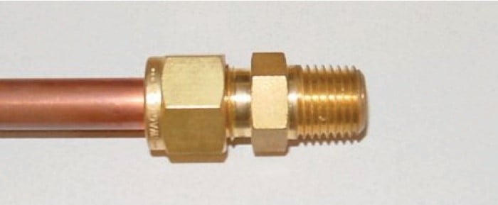 slightly crimping the tube thereby locking the ferrules in place